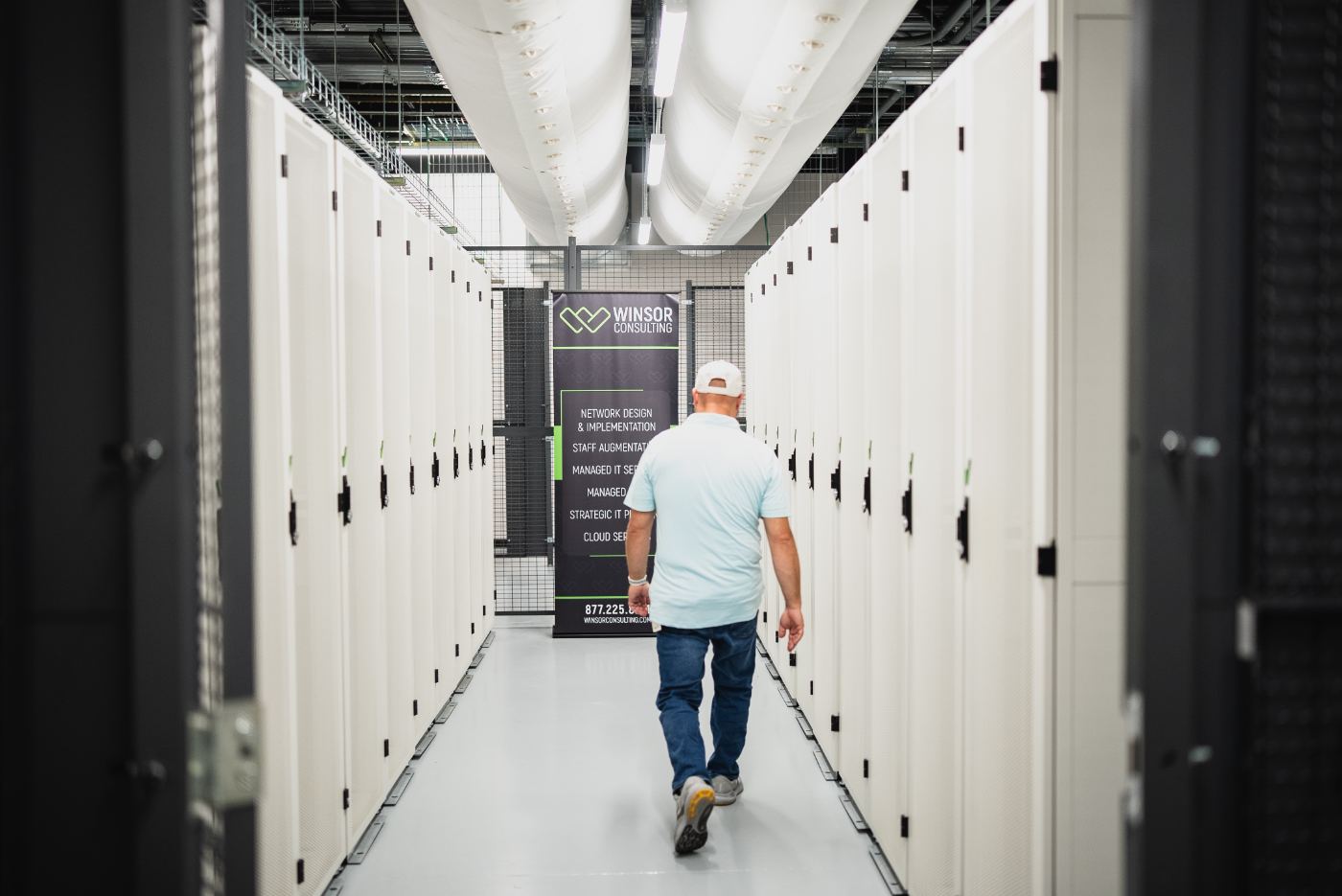 Caged white server cabinets in the data hall
