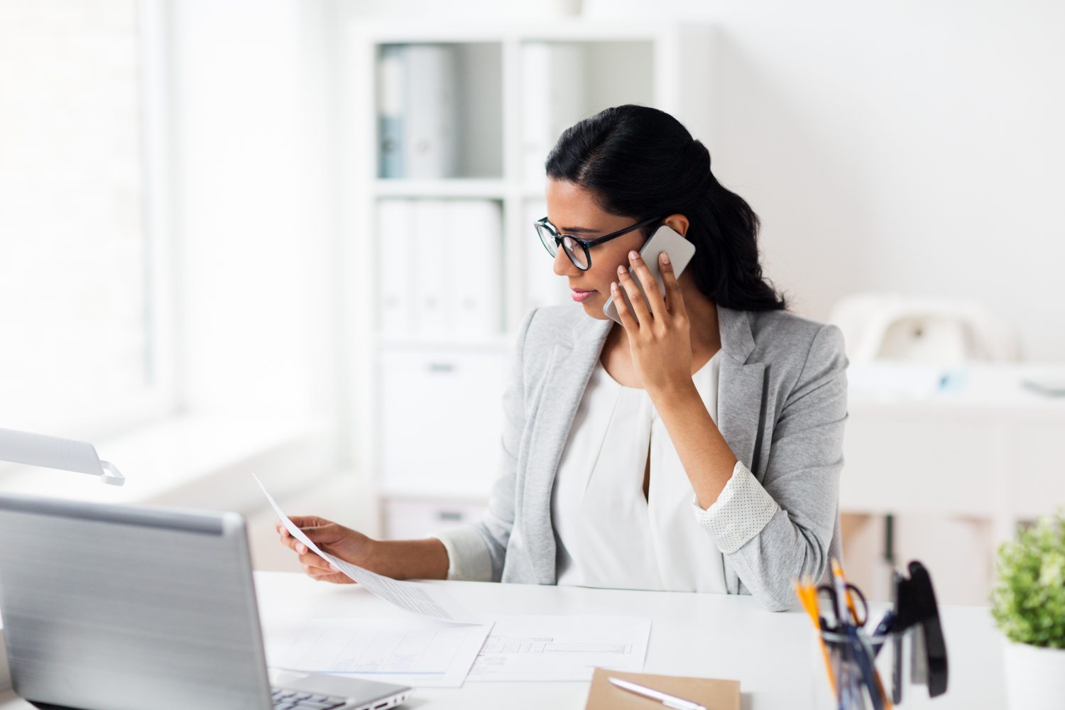Operations leader reviewing network security at her desk